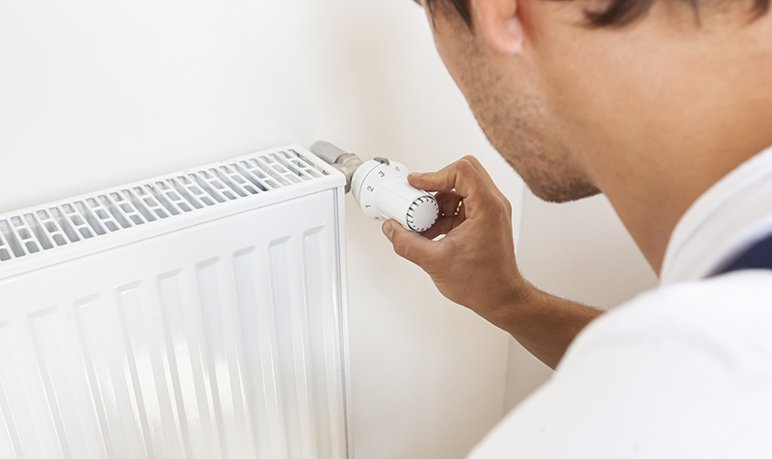 man-increase-temperature-radiator-by-adjusting-thermostat1.jpg